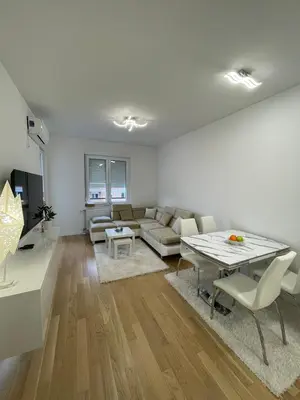 a living room with a couch and a table at Apartman Blok 51 in Banja Luka