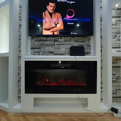a fireplace in a tv stand with a television at Apartmani AMONA STAN NA DAN in Doboj