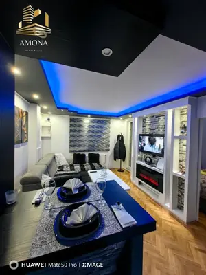 a modern living room with a blue ceiling at Apartmani AMONA STAN NA DAN in Doboj