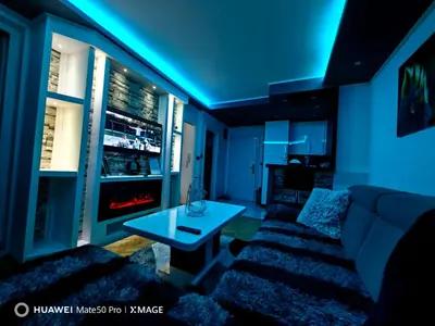 a living room with a couch and a table at Apartmani AMONA STAN NA DAN in Doboj