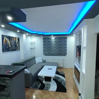 a living room with a couch and a table at Apartmani AMONA STAN NA DAN in Doboj