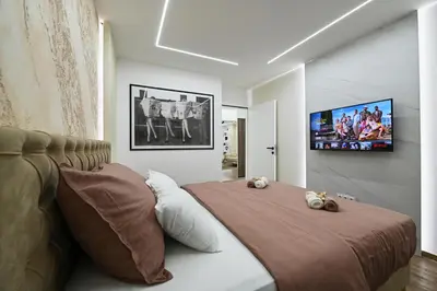 a bedroom with a bed with two stuffed animals on it at Apartman 52 in Doboj