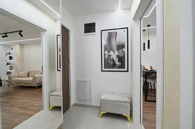 a living room with a mirror and a chair at Apartman 52 in Doboj
