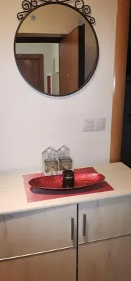a red plate on a counter under a mirror at Sweet Dreams RD in Travnik