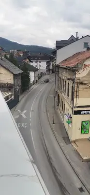 an empty street in a town with a car on the road at Sweet Dreams RD in Travnik