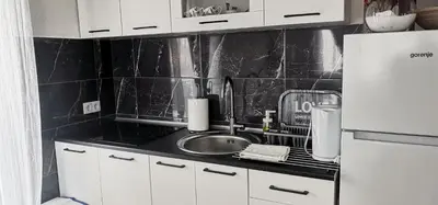 a kitchen with a sink and a white refrigerator at Sweet Dreams RD in Travnik