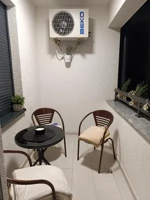 a room with a table and chairs and a fan at Apartman 7 Ladies in Banja Luka