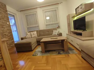 a living room with a couch and a tv at Mila apartman in Banja Luka