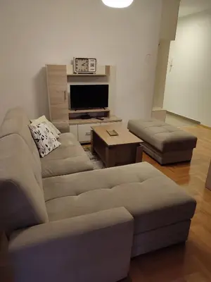 a living room with a couch and a tv at Mila apartman in Banja Luka