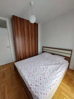 a bedroom with a bed with a polka dot blanket at Mila apartman in Banja Luka