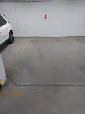 a white car parked in a parking lot at Mila apartman in Banja Luka