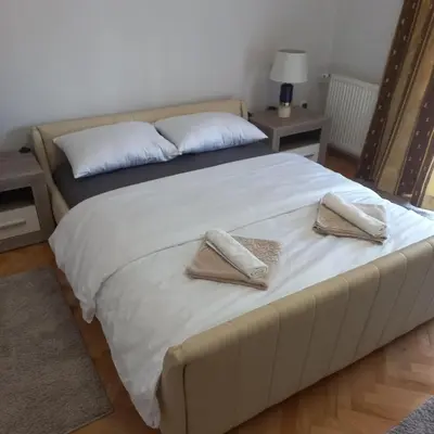 a bedroom with a bed with two pillows on it at Nova DOM in Banja Luka
