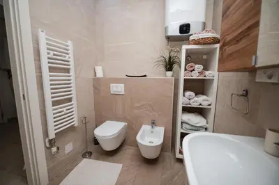 a small bathroom with a toilet and a sink at City Museum Apartments Banja Luka in Banja Luka