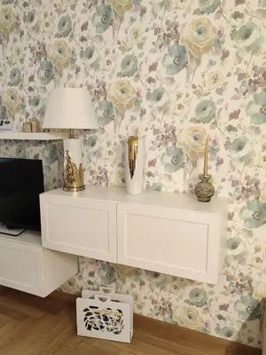 a white desk with a lamp and a flowery wallpaper at City Museum Apartments Banja Luka in Banja Luka