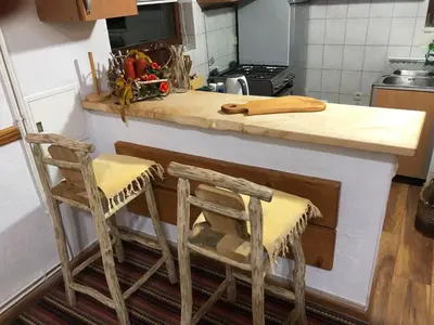 a kitchen with two wooden chairs and a counter top at Dream House in Kupres