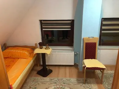 a bedroom with a bed and a mirror and a chair at Dream House in Kupres