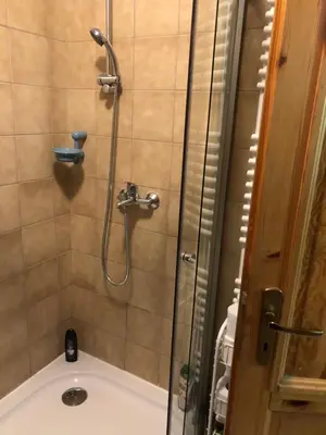 a bathroom with a shower and a tub with a shower at Dream House in Kupres