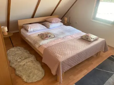a bedroom with a bed and a rug at Dream House in Kupres