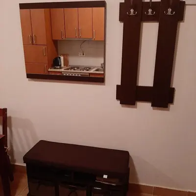a kitchen with brown cabinets and a mirror on the wall at Apartman Pahuljica Vlašić in Vlasic