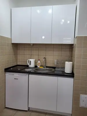 a kitchen with white cabinets and a sink at Lavander in Banja Luka