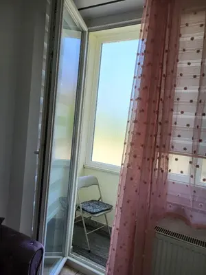 a room with a window with a chair at Lavander in Banja Luka