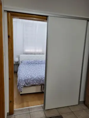 a bedroom with a bed through a sliding glass door at Lavander in Banja Luka