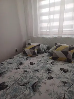 a bedroom with a bed with pillows and a window at Lavander in Banja Luka