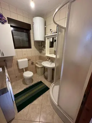 a bathroom with a shower and a toilet and a sink at Kuća za odmor VITICA s vanjskim kaminom in Kupres