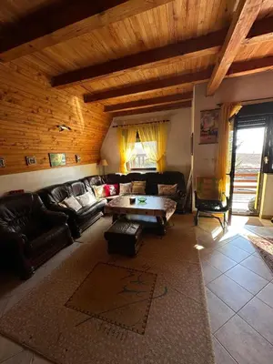 a living room with a couch and a table at Kuća za odmor VITICA s vanjskim kaminom in Kupres