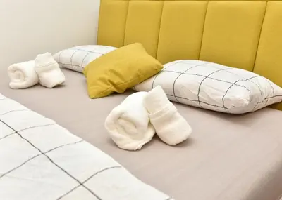 a room with two white towels on a bed at Apartmani TIS in Banja Luka