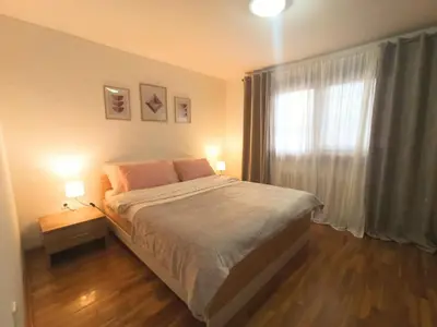 a bedroom with a large bed and a window at Kuća za odmor La Mia Casa in Doboj