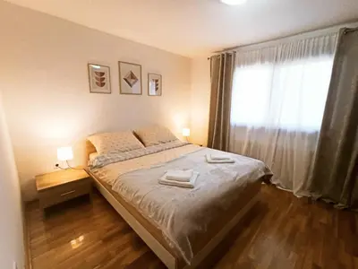 a bedroom with a large bed and a window at Kuća za odmor La Mia Casa in Doboj