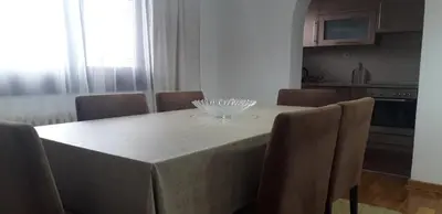 a dining room table with chairs and a bowl on it at Kuća za odmor La Mia Casa in Doboj