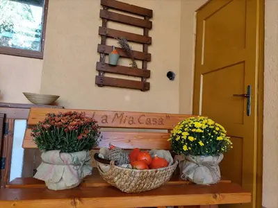 three baskets of fruit and flowers sitting on a bench at Kuća za odmor La Mia Casa in Doboj