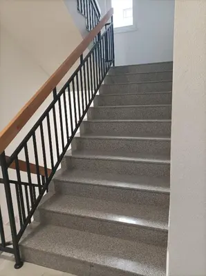 a staircase in a house with grey carpet at Delta Lux Apartment in Banja Luka