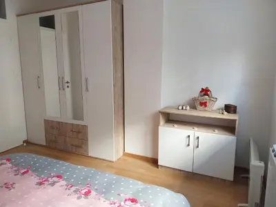 a bedroom with a bed and a cabinet in it at Delta Lux Apartment in Banja Luka