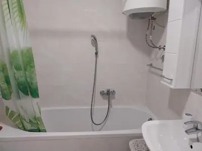 a bathroom with a shower and a tub and a sink at Delta Lux Apartment in Banja Luka