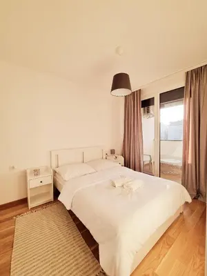 a bedroom with a large white bed and a window at Cozy Home Apartment Banja Luka in Banja Luka