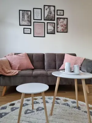 a living room with a couch and two tables at Cozy Home Apartment Banja Luka in Banja Luka