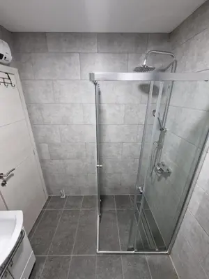 a shower with a glass door in a bathroom at Apartments Gradiska in Bosanska Gradiška