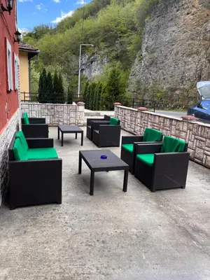 a group of couches and tables on a patio at Apart Cobras Jajce in Jajce