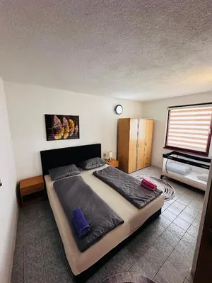 a bedroom with a large bed and a television at Apart Cobras Jajce in Jajce