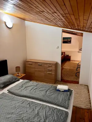 a bedroom with a bed and a wooden ceiling at Apart Cobras Jajce in Jajce
