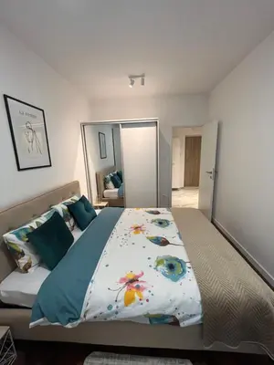 a bedroom with a large bed and a large mirror at Apartman Lux Moli Banja Luka in Banja Luka