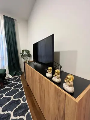 a living room with a flat screen tv on a cabinet at Apartman Lux Moli Banja Luka in Banja Luka