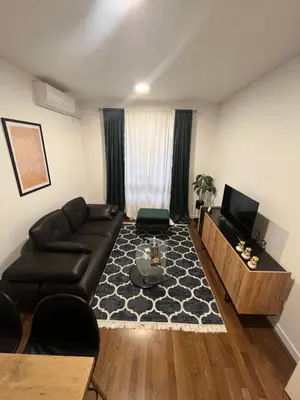 a living room with a couch and a tv at Apartman Lux Moli Banja Luka in Banja Luka