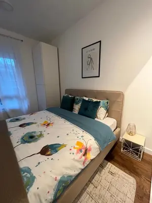 a bedroom with a bed with a colorful comforter at Apartman Lux Moli Banja Luka in Banja Luka