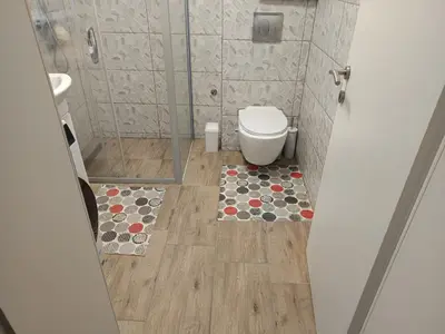a small bathroom with a toilet and a shower at Apartment Lane in Bihać