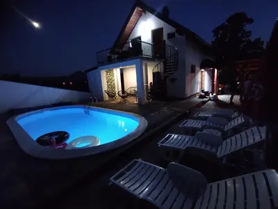 a swimming pool in the middle of a yard at night at La Mia Casa in Bihać
