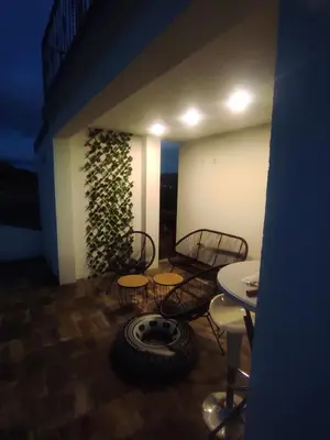 a room with chairs and a table and a tire at La Mia Casa in Bihać